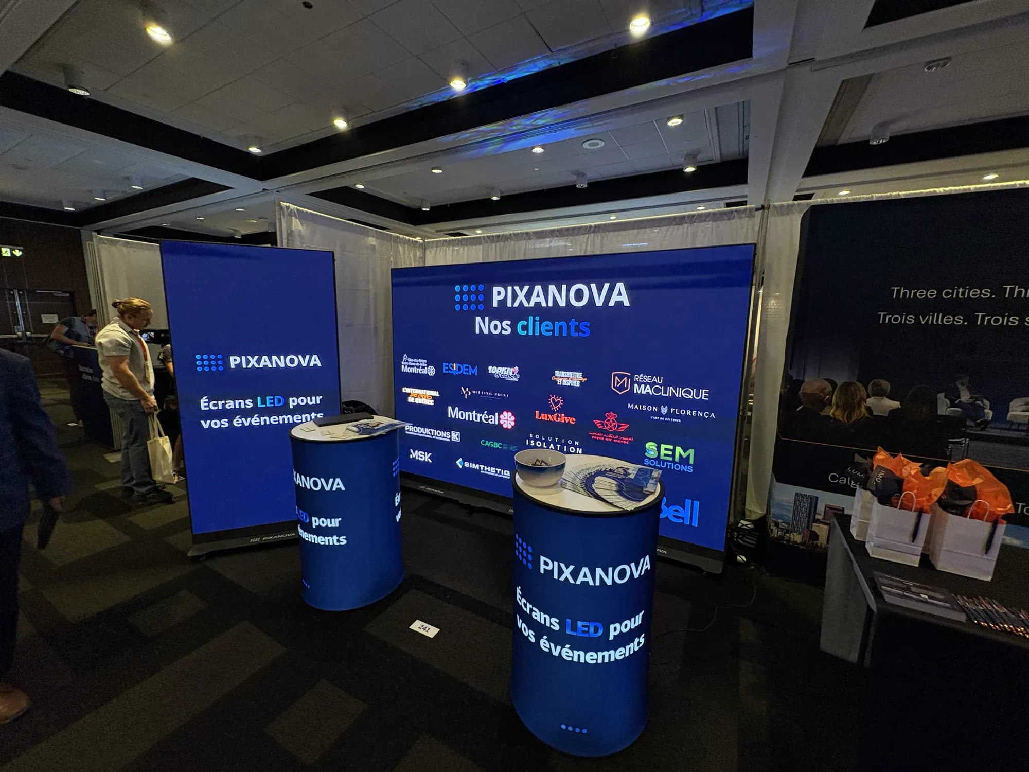 Pixanova booth at the Momentum Trade Show: client logo wall and LED totem screens